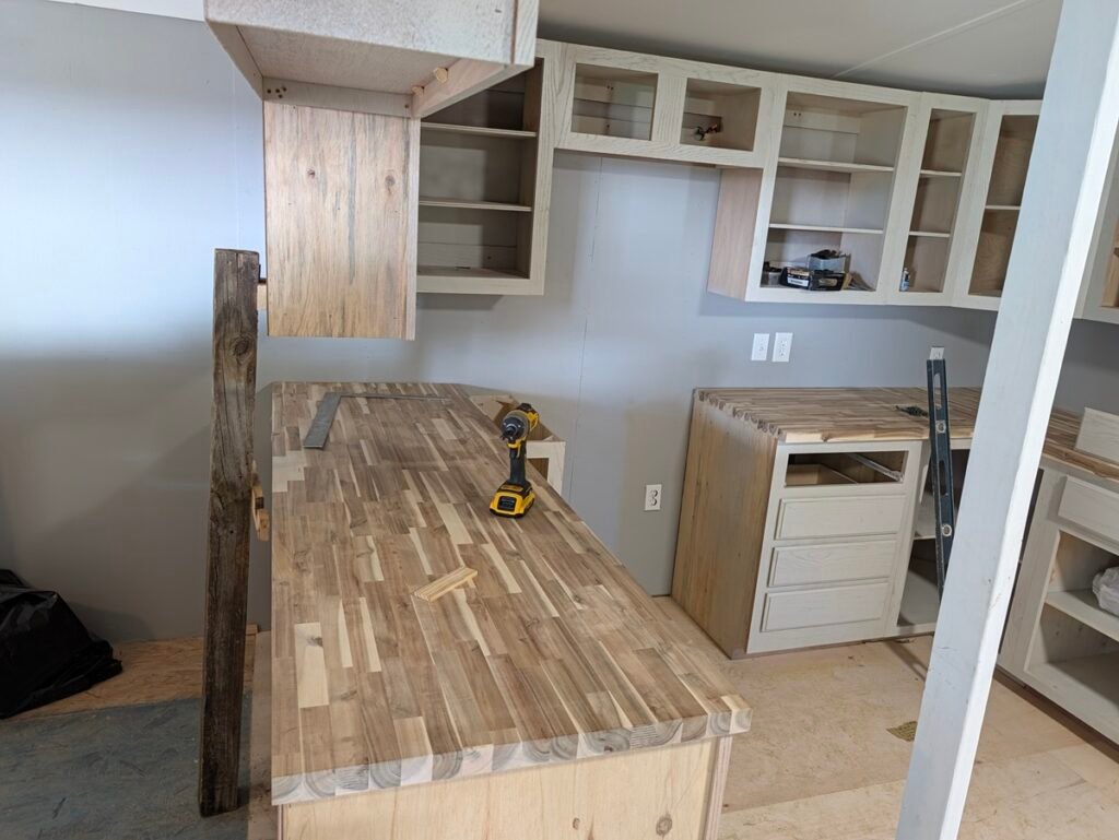 Butcher block slab installed on a long kitchen peninsula bar with framing square