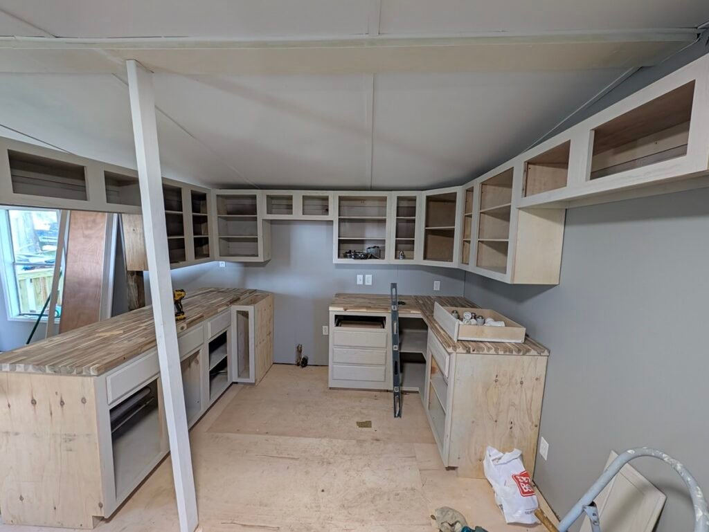 Full kitchen view showing how to install butcher block countertops on base cabinets
