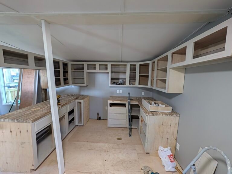Full kitchen view showing how to install butcher block countertops on base cabinets