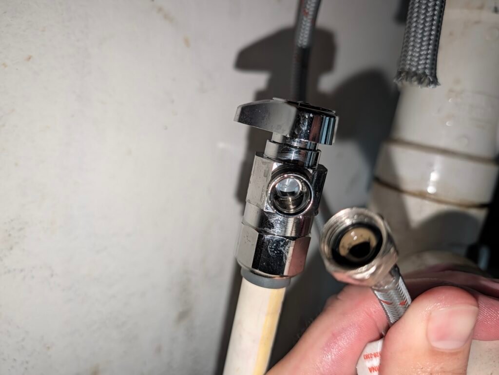 An escutcheon deck plate cleanly seals the unused outer holes on a three-hole sink deck.