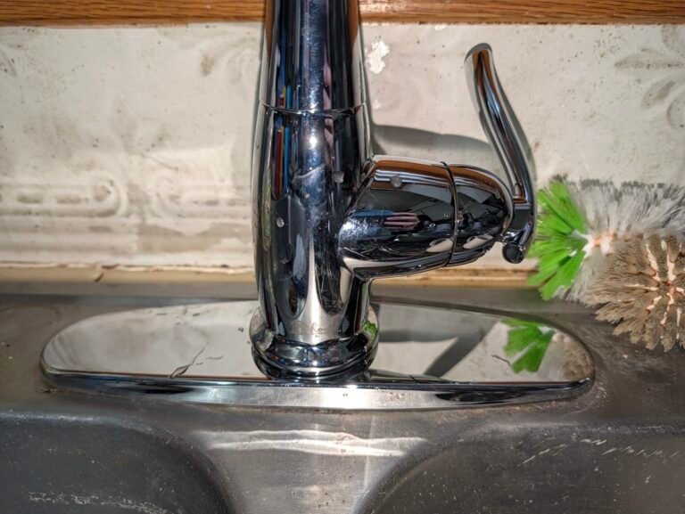 How to replace a kitchen faucet: newly installed single handle chrome faucet on a stainless steel sink