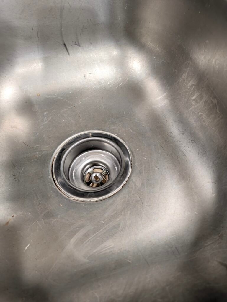 Cleaned top rim showing how to replace a kitchen sink basket strainer correctly
