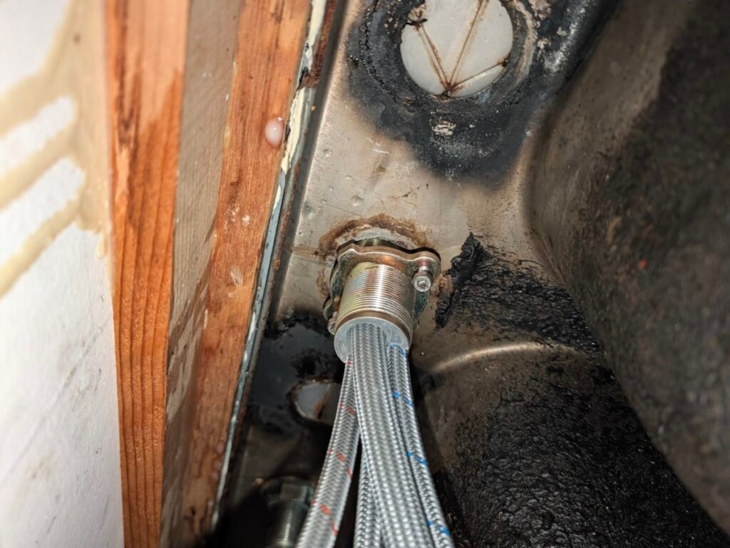 Slide all flexible lines through the mounting nut first before hand-threading the collar up the brass shank.
