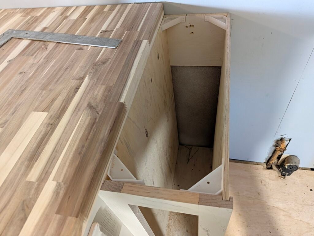 Corner mounting brackets inside a narrow 9-inch kitchen base cabinet