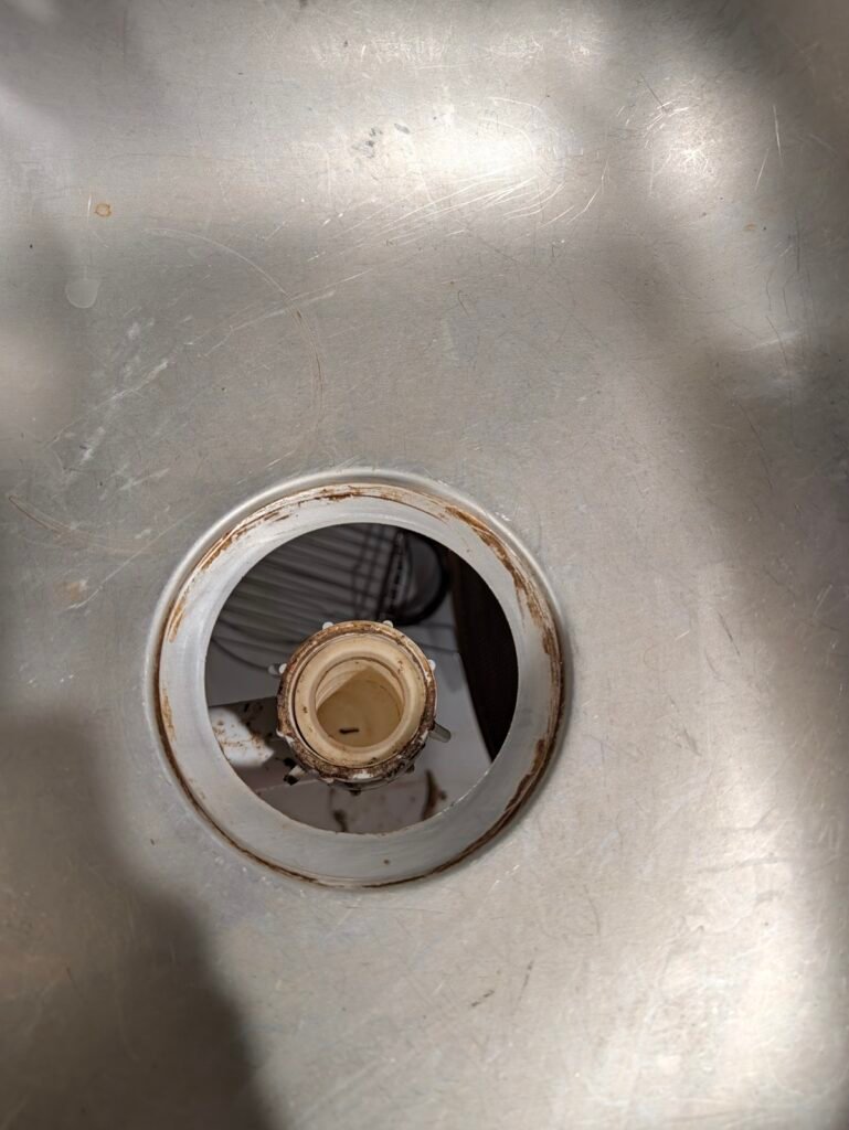 Cleaned kitchen sink drain opening ready for basket strainer replacement