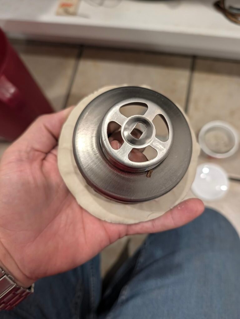 Applying a plumber's putty rope before you replace a kitchen sink basket strainer
