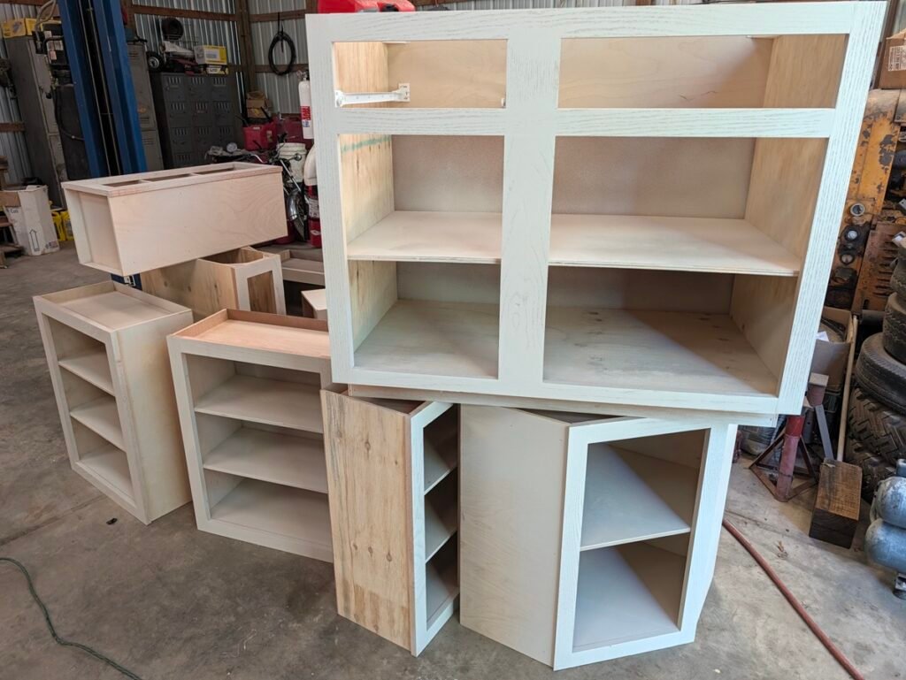 Corner base cabinet and drawer base staged for painting